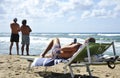 Two types of contemplation of our technological age. A single man contemplates his smartphone while two friends contemplate the in Royalty Free Stock Photo