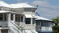 Two styles of Queenslander homes with tin roof and verandahs