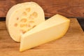 Two types of semi-hard cheese on cutting board closeup