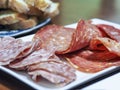 Two types of sliced salami on a serving plate as catering concept