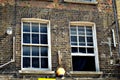 Two typical British window in a brick wall Royalty Free Stock Photo