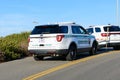 Two U.S. Park Ranger law enforcement SUV vehicles of National Park Service are blocking traffic on the road leading tidepools at
