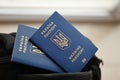Two ukrainian biometrical passports on black touristic backpack