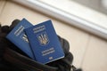 Two ukrainian biometrical passports on black touristic backpack