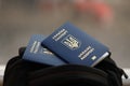 Two ukrainian biometrical passports on black touristic backpack