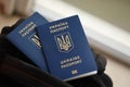 Two ukrainian biometrical passports on black touristic backpack