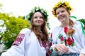 two Ukrainian young women dancing in wind develops hair and flowers near wreath on heads embroidered shirts girls Royalty Free Stock Photo