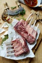Two uncooked racks of lamb with fresh herbs Royalty Free Stock Photo
