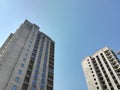 Two unfinished multi-storey residential building on a Sunny day against the blue sky. Empty apartment. Bottom-up view.