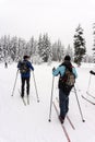 Two unidentified male skiers on a cross-country tour in snowy weather