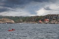 Two unidentified persons kayaking in the ocean in the coast of Sweden