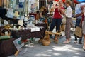 Two unidentified women make a purchase at a flea market near the city center. Editorial only.