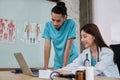 Two uniformed young doctors work in medical clinic office Royalty Free Stock Photo