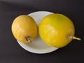 Two units of passion fruit on white plate, on black background. Royalty Free Stock Photo