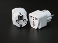 Two universal power adapter on black background Royalty Free Stock Photo