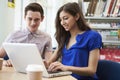 Two University Students Working In Library Using Laptop Royalty Free Stock Photo