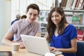 Two University Students Working In Library Using Laptop Royalty Free Stock Photo