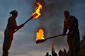 Two unknown men hold burning torches during the Nowruz / Novruz celebration near the city of Akre in Kurdish Iraq, a local traditi