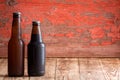 Two unlabelled beer bottles of different shapes