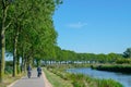 Two unrecognizable cyclists cycle in polder