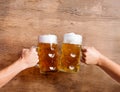 Two unrecognizable men clinking with beer mugs, studio shot Royalty Free Stock Photo