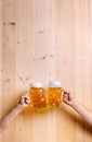 Two unrecognizable men clinking with beer mugs, studio shot Royalty Free Stock Photo