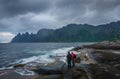 Two unrecognizable people stand on Tungeneset beach on Senja Island in Norway