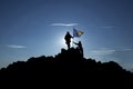 Two unrecognizable soldiers raise the Bosnuan flag