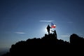 Two unrecognizable soldiers raise the Chilean flag