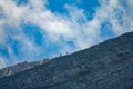 Two unrecognizable tourists hike along the majestic rocky mountain in Slovenia. Royalty Free Stock Photo