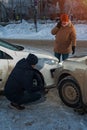 Two upset male drivers looking at cars after crash Royalty Free Stock Photo