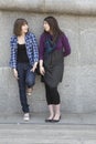 Two urban teen girls standing at wall Royalty Free Stock Photo