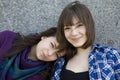 Two urban teen girls standing at wall. Royalty Free Stock Photo