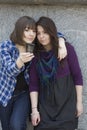 Two urban teen girls taking photo by mobile phone Royalty Free Stock Photo