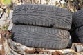 Two used car tires with detailed tread pattern lying on rusty surface outdoors. Royalty Free Stock Photo