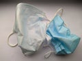 two used disposable medical masks on a white background close up photo Royalty Free Stock Photo