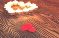 Two hearts, burning candles on wooden. Valentine`s Day. Royalty Free Stock Photo