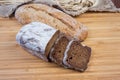 Two varities of the brown bread on wooden cutting board Royalty Free Stock Photo