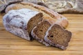 Two varities of brown bread on wooden surface close-up Royalty Free Stock Photo