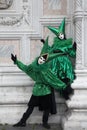 Two Venice Carnival costumes in green and black with Venice masks in February's Venice Carnival, Italy