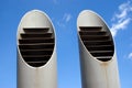 Two ventilation pipes over blue sky closeup Royalty Free Stock Photo