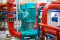 Two vertical engines painted blue with pumps connected to pipes painted red. Royalty Free Stock Photo