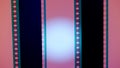 Two vertical film strips on a pink background with white circular light, close up. 35mm film slide frame. Long, retro Royalty Free Stock Photo