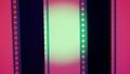 Two vertical film strips on a red background with green circular light, close up. 35mm film slide frame. Long, retro Royalty Free Stock Photo