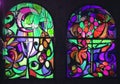 Two vertical stained glass windows with abstract background of multicolored glass with floral and fruit ornaments