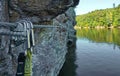 Two via ferrata carabiners on steel rope at rock above river