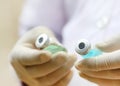 Two vials holding by a doctor Royalty Free Stock Photo
