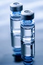 Two vials of water sitting on top of a table Royalty Free Stock Photo
