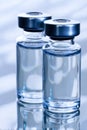 Two vials of water sitting on top of a table Royalty Free Stock Photo