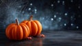 Two vibrant orange pumpkins placed on dark stone surface with cobweb and tiny spiders nearby. Eerie setting evokes Royalty Free Stock Photo